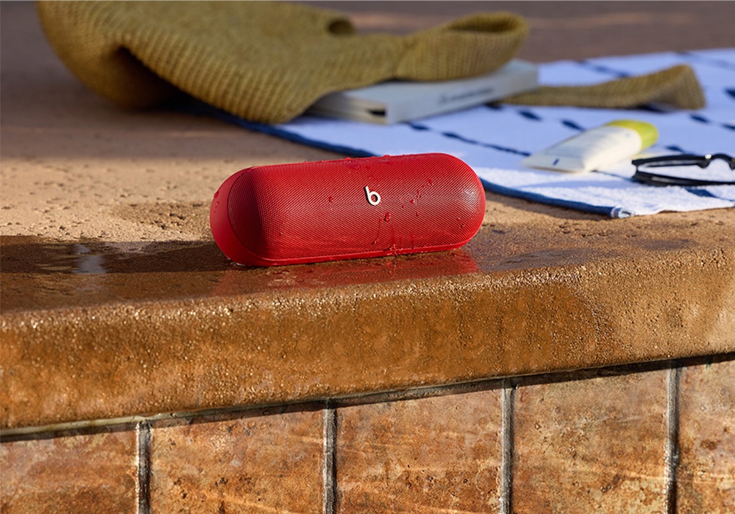 Red Beats Pill speaker near water