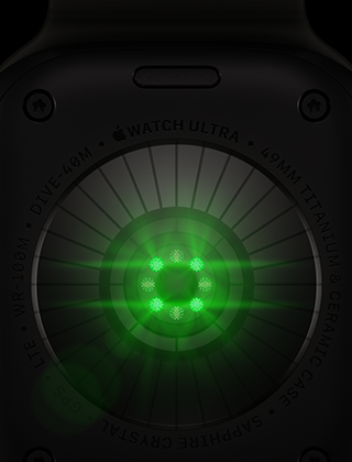„Apple Watch Ultra 4“ galinė pusė, titano korpusas, juoda spalva, keli apvalūs jutikliai su švytinčiais žaliais LED šviesos diodais